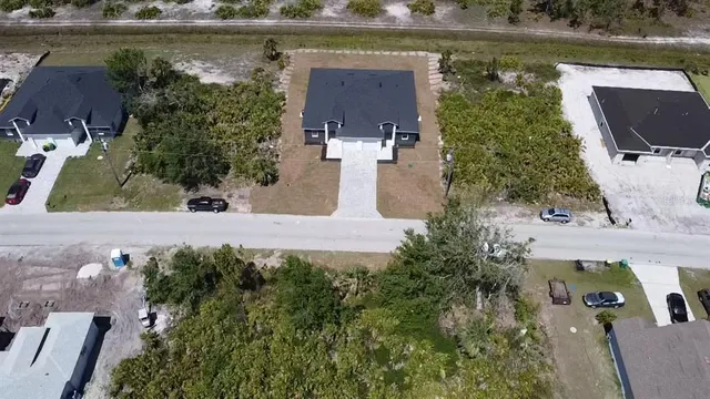 an aerial view of a house with a lake view