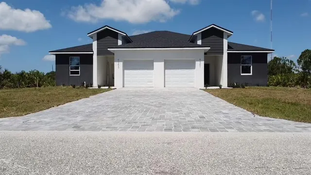 a front view of a house with a yard and garage