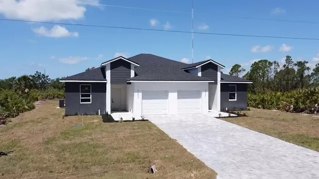 a front view of a house with a yard and garage