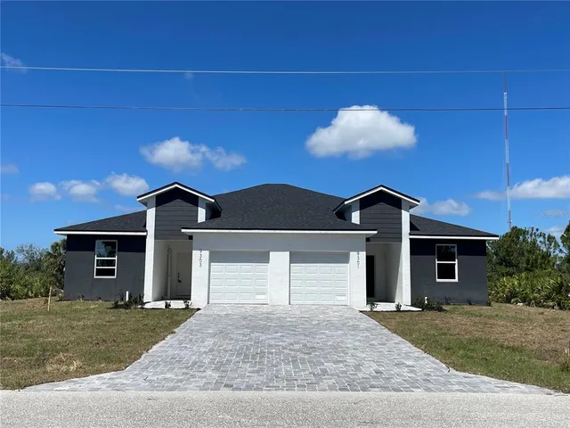 a front view of a house with a yard and garage