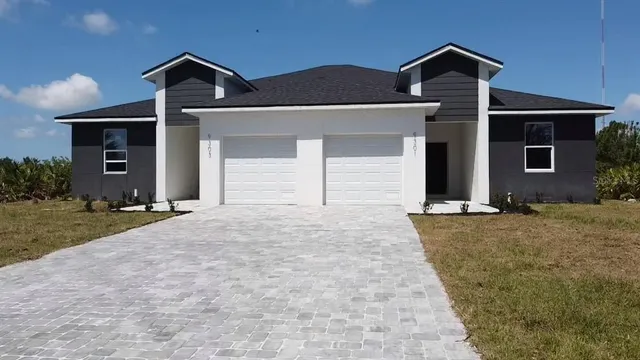 a front view of a house with a yard and garage