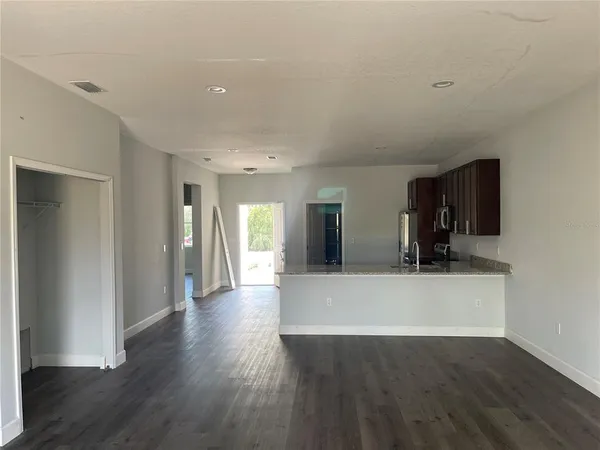 a view of a living room with wooden floor