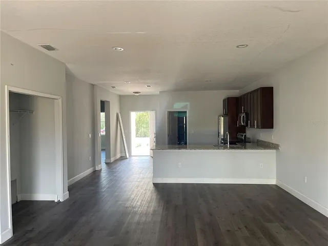 a view of a living room with wooden floor