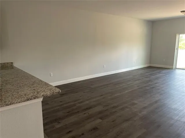 a view of wooden floor and cabinets in a room