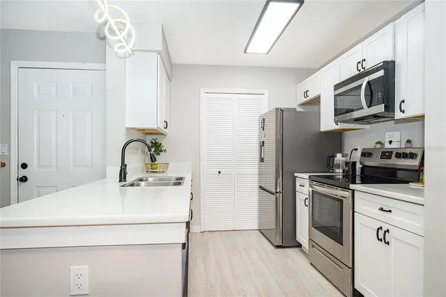 a kitchen with stainless steel appliances a refrigerator stove and microwave