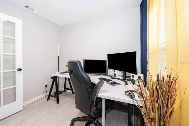 a view of a workspace with furniture