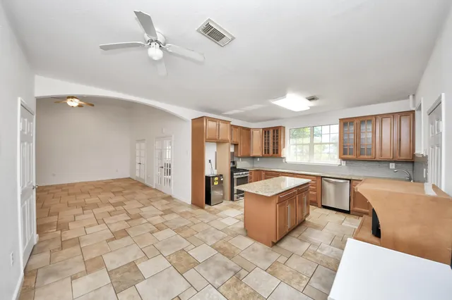 a large white kitchen with cabinets and a sink