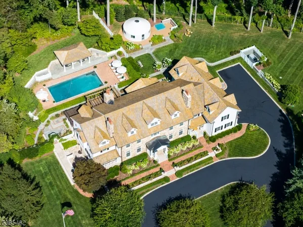 an aerial view of a house with a yard basket ball court and outdoor seating