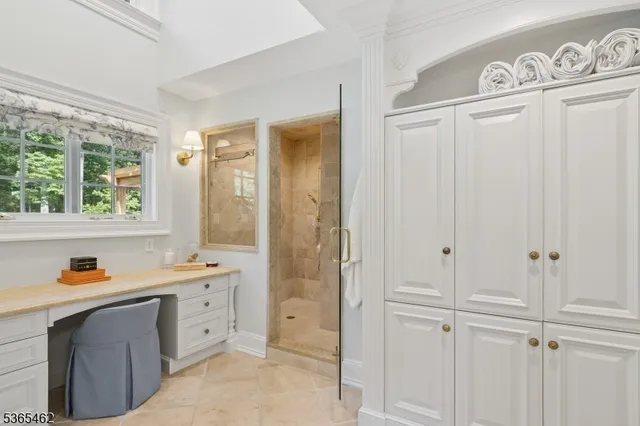 a bedroom with a bed and glass windows