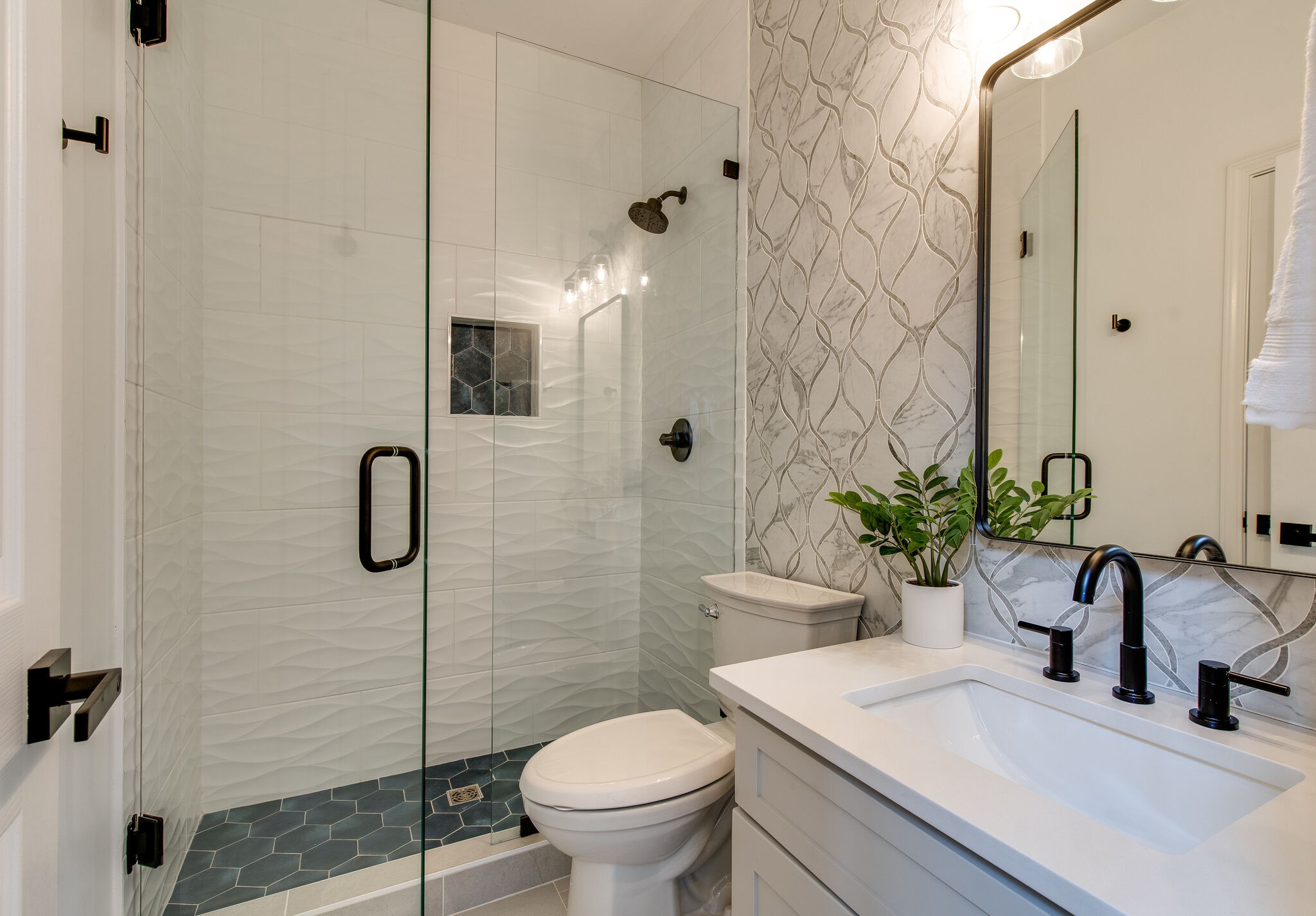 134 Stanwick Drive Franklin, TN 37067 - Photo 11 of 46 a bathroom with a sink a toilet a glass door a shower and a mirror