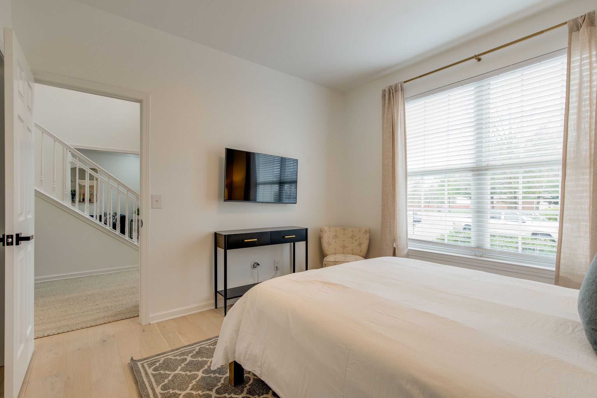 134 Stanwick Drive Franklin, TN 37067 - Photo 10 of 46 a spacious bedroom with a large bed a flat tv screen and a dresser