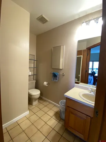 a bathroom with a toilet a sink and mirror