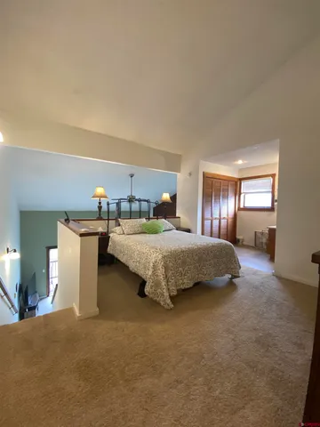 a bedroom with a large bed and window