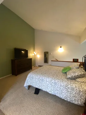 a bedroom with a bed and a lamp on roof