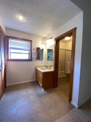 a large bathroom with a large tub and sink
