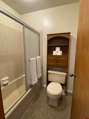 a bathroom with a toilet and a shower