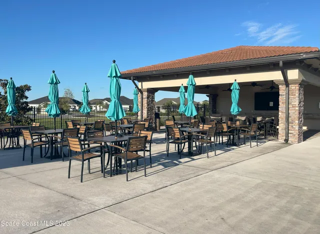 a view of a terrace with furniture and umbrella