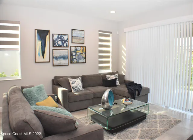 a living room with furniture and a large window