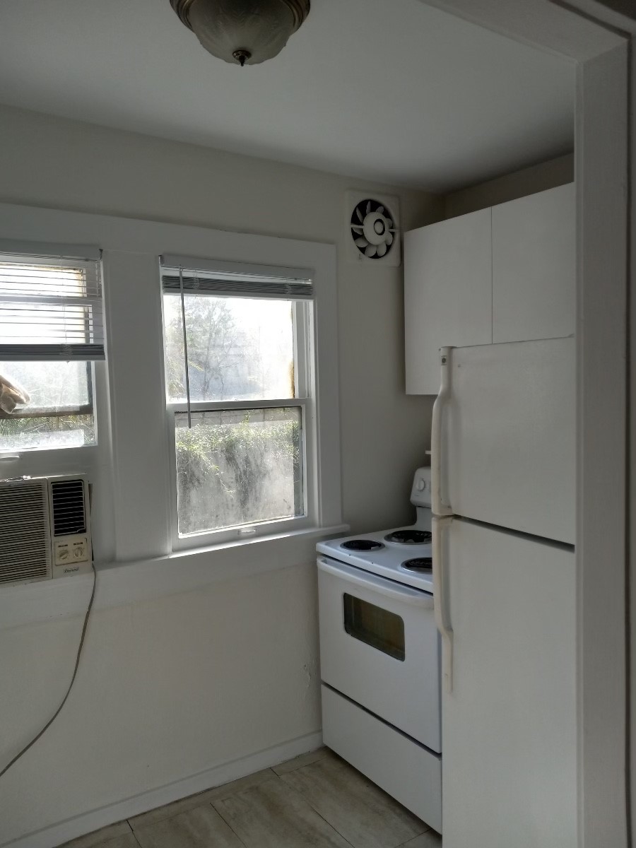 4309 Jack Street, Unit 3 Houston, TX 77006 - Photo 2 of 6 a kitchen with white cabinets and white appliances