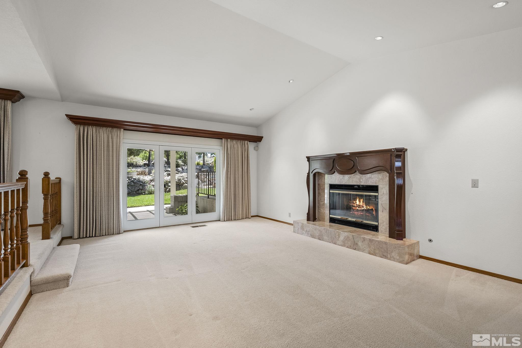 15 Pecetti Circle Reno, NV 89511 - Photo 6 of 40 a view of an empty room with a fireplace and a window