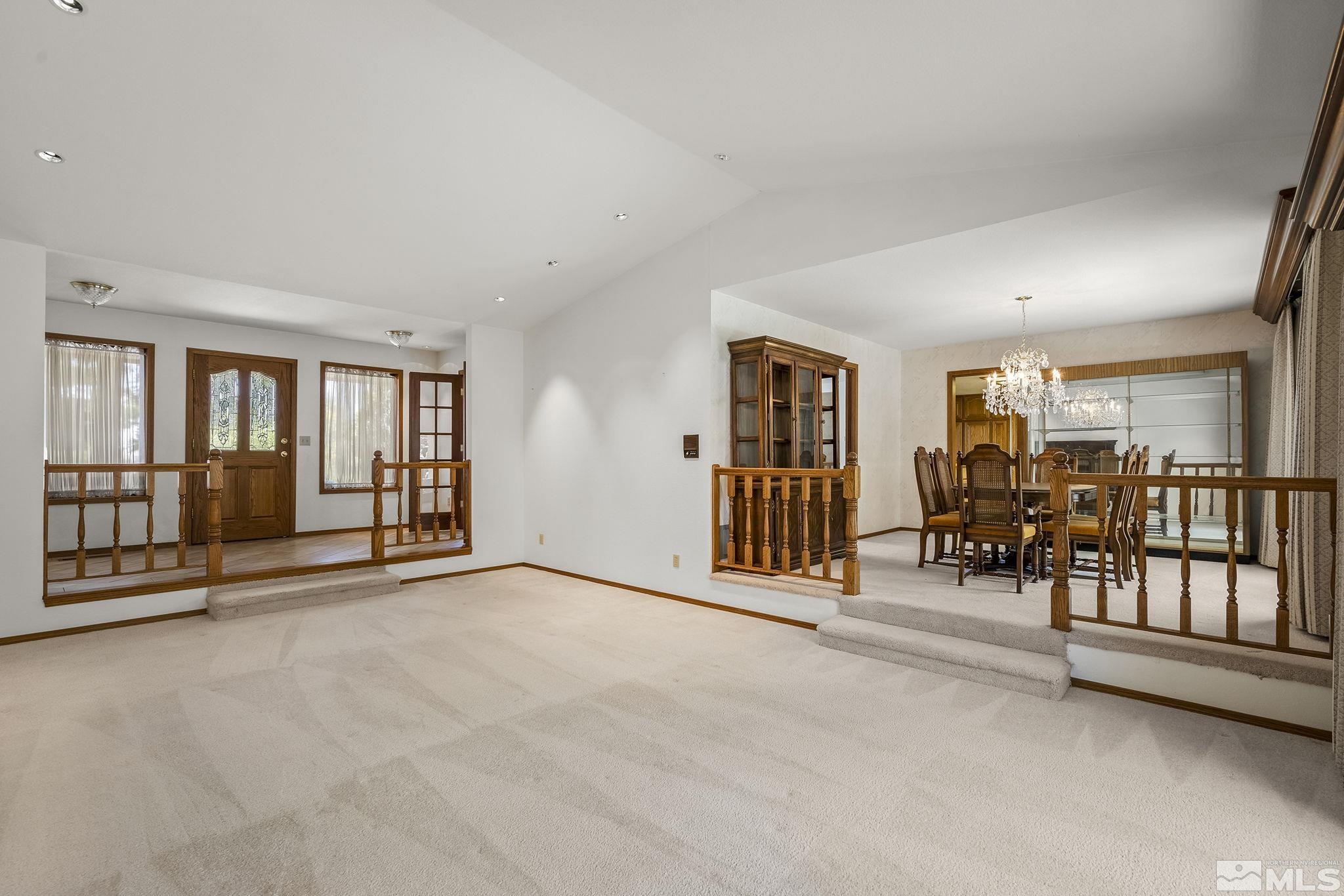 15 Pecetti Circle Reno, NV 89511 - Photo 7 of 40 an empty room with stairs and large windows