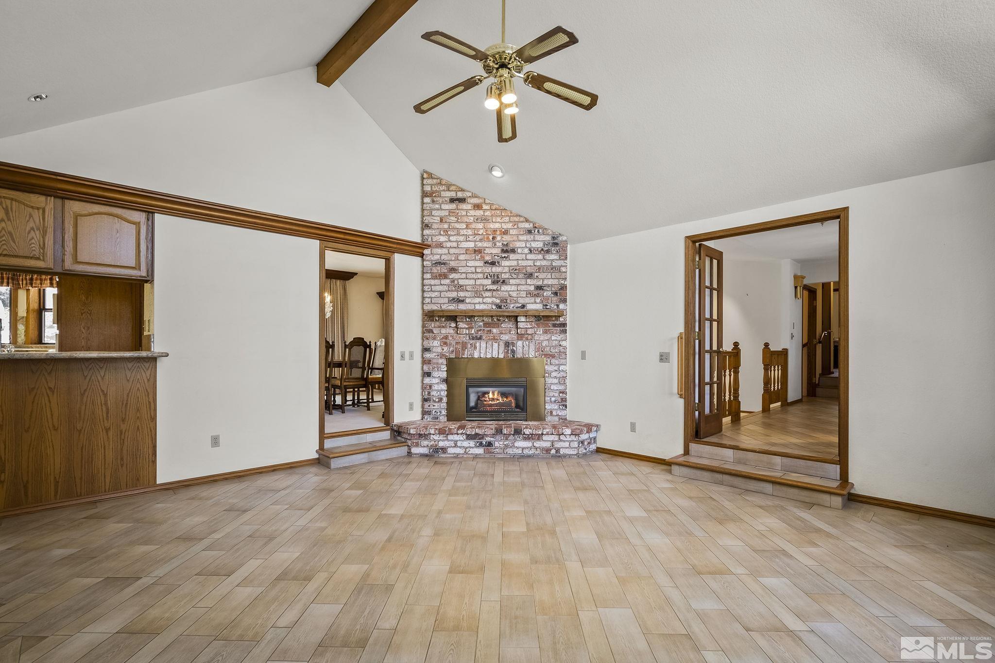 15 Pecetti Circle Reno, NV 89511 - Photo 9 of 40 a view of a livingroom with a fireplace a ceiling fan and window
