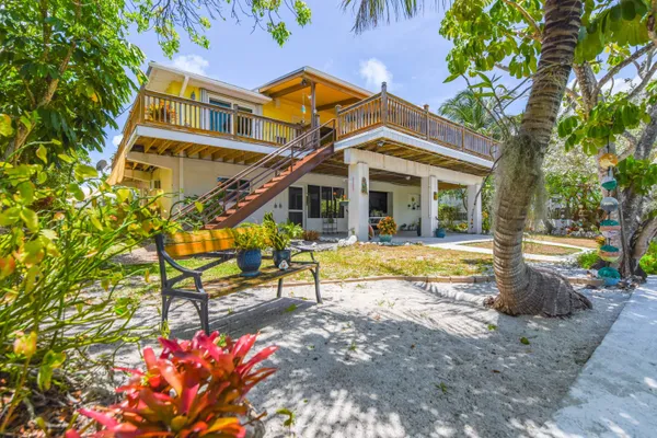 a view of a house with swimming pool and sitting area