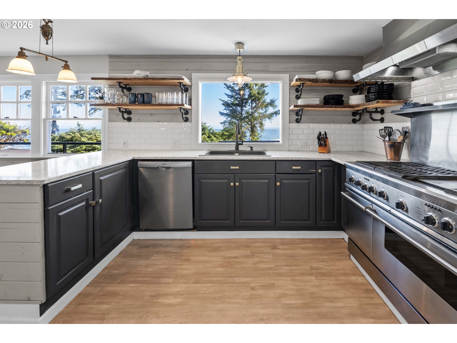 3232 Sunset Boulevard Seaside, OR 97138 - Photo 9 of 48 a kitchen with stainless steel appliances granite countertop a sink stove and cabinets