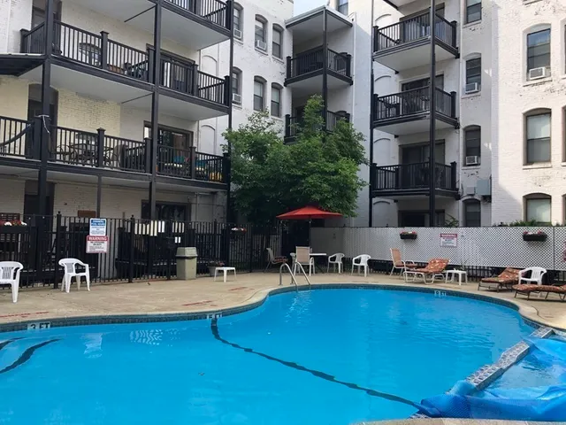 a swimming pool with outdoor seating and yard