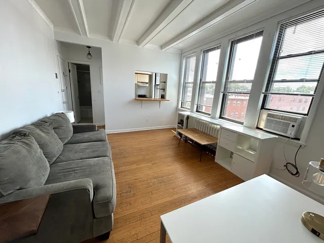a living room with furniture and large windows