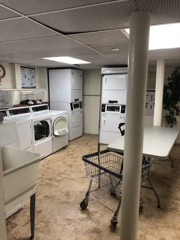 a room with furniture a rug and white walls