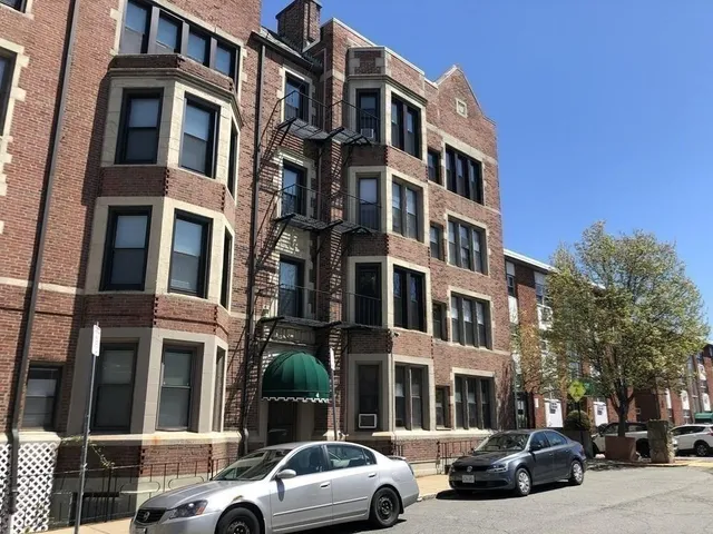 a couple of cars parked in front of a building