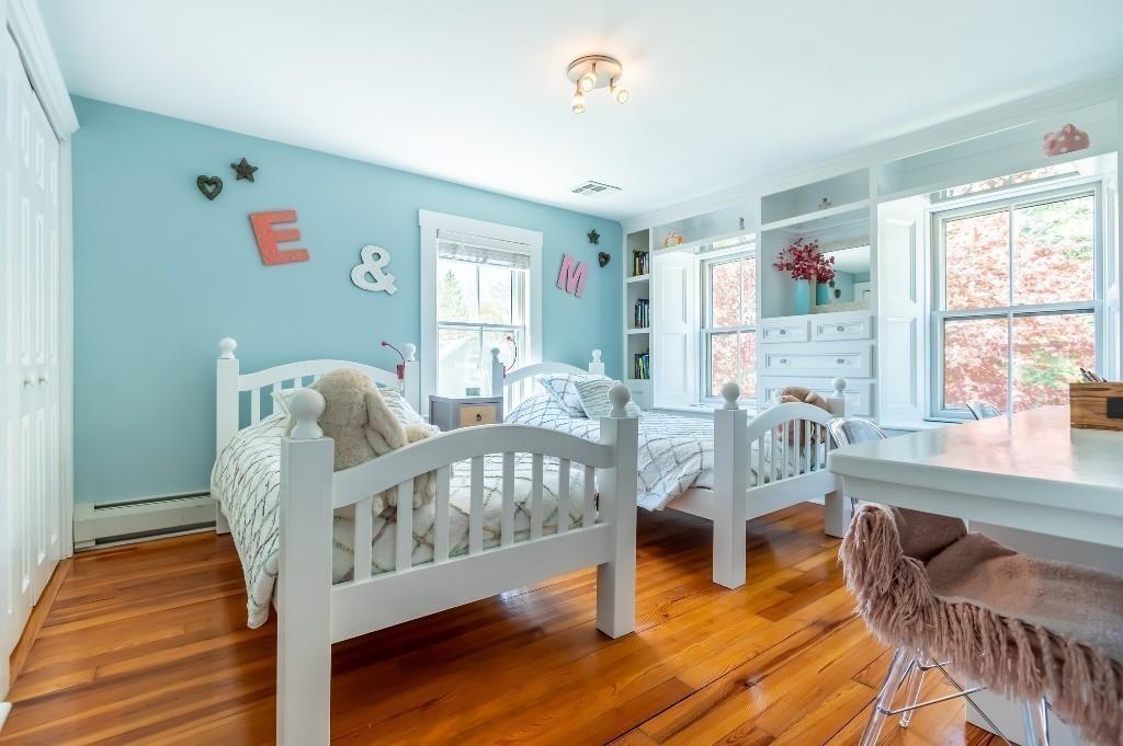 207 Highland Road Andover, MA 01810 - Photo 19 of 35 a living room with furniture a wooden floor and a large window