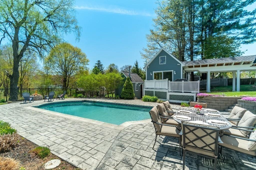 207 Highland Road Andover, MA 01810 - Photo 27 of 35 a patio with a table and chairs and potted plants