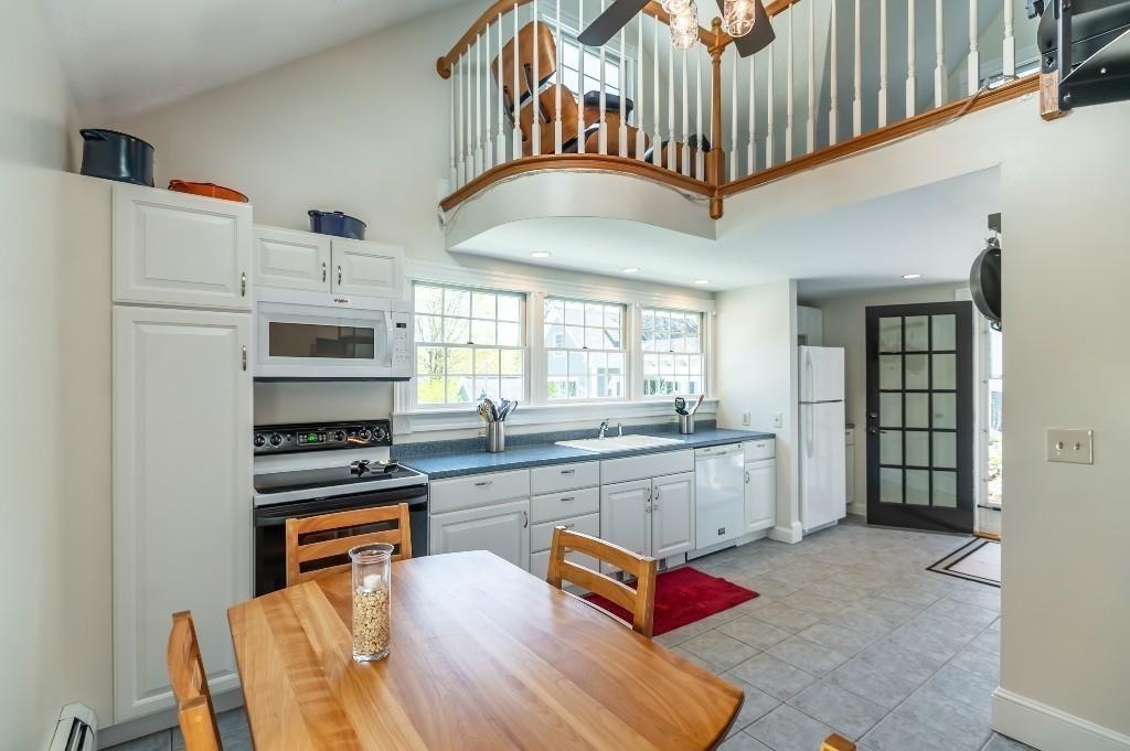 207 Highland Road Andover, MA 01810 - Photo 30 of 35 a kitchen with stainless steel appliances granite countertop a stove a refrigerator and a cabinets