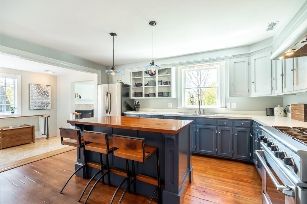 207 Highland Road Andover, MA 01810 - Photo 6 of 35 a kitchen with stainless steel appliances granite countertop a stove and white cabinets