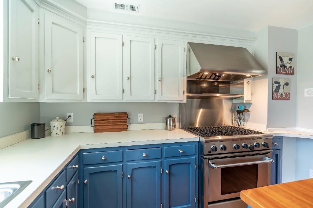 207 Highland Road Andover, MA 01810 - Photo 8 of 35 a kitchen with stainless steel appliances a stove and white cabinets