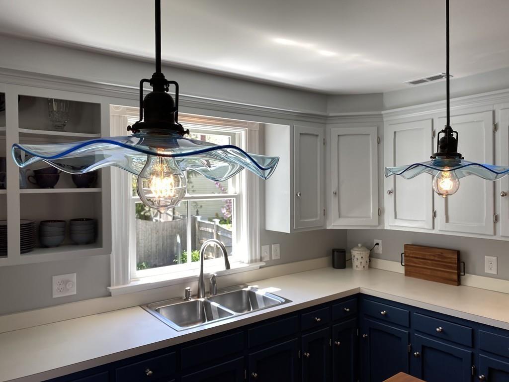 207 Highland Road Andover, MA 01810 - Photo 9 of 35 a kitchen with stainless steel appliances a sink and cabinets