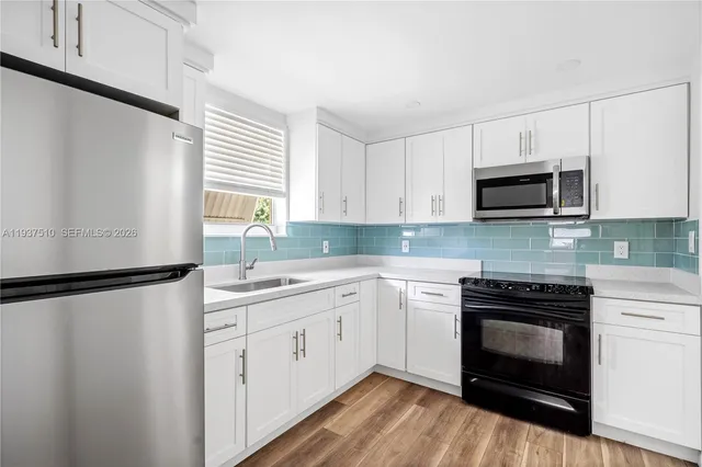 a kitchen with a sink stove and microwave