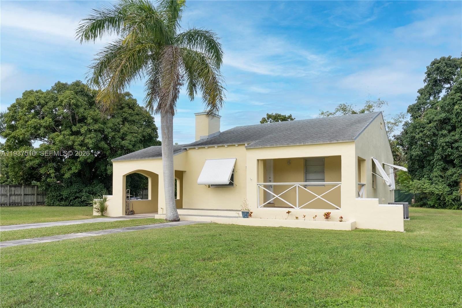 27 Northwest 21st Street Homestead, FL 33030 - Photo 2 of 10 a backyard of a house with table and chairs