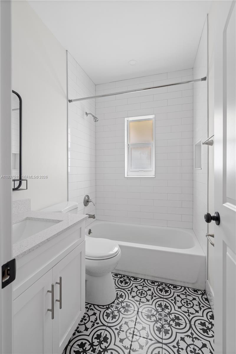 27 Northwest 21st Street Homestead, FL 33030 - Photo 6 of 10 a bathroom with a granite countertop sink toilet and shower