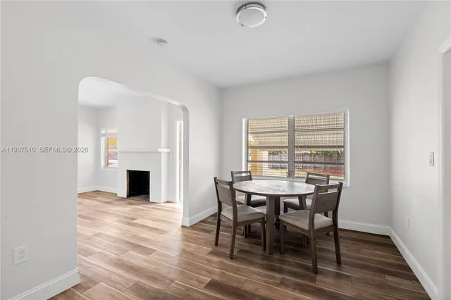 a view of a dining room with furniture and fireplace