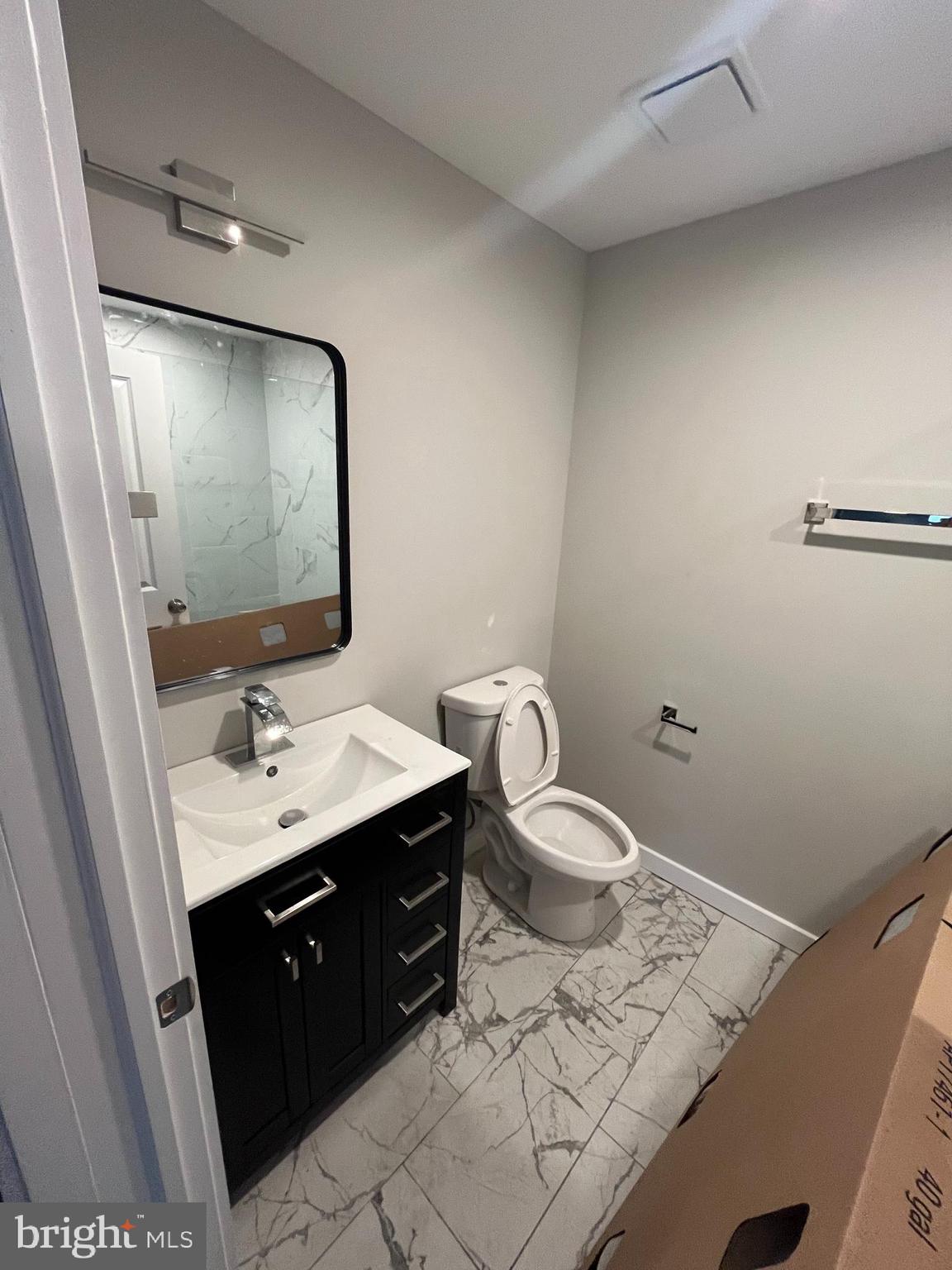 36 North Narberth Avenue, Unit 1A Narberth, PA 19072 - Photo 3 of 4 a bathroom with a sink toilet and mirror