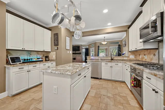 a kitchen with stainless steel appliances granite countertop a sink and cabinets