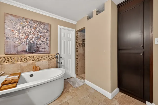 a bathroom with a tub sink and mirror