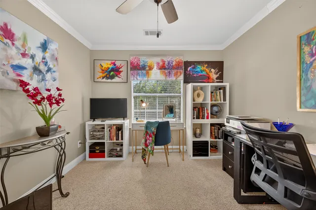 a view of a livingroom with workspace and a window