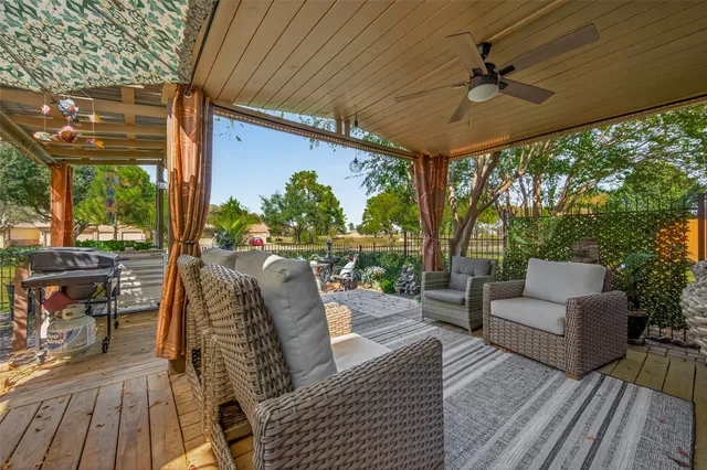 a balcony with furniture and wooden floor