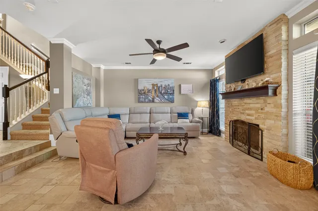 a living room with furniture a fireplace and a flat screen tv