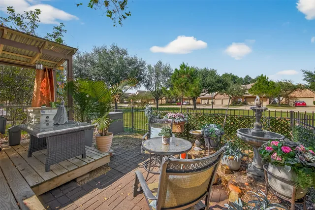 a view of a patio with couches table and chairs and potted plants