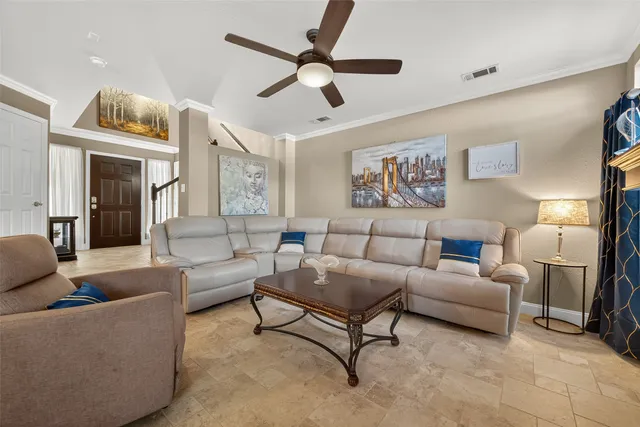 a living room with furniture and a chandelier